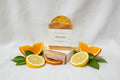 Bar of soap with orange slices on a white background