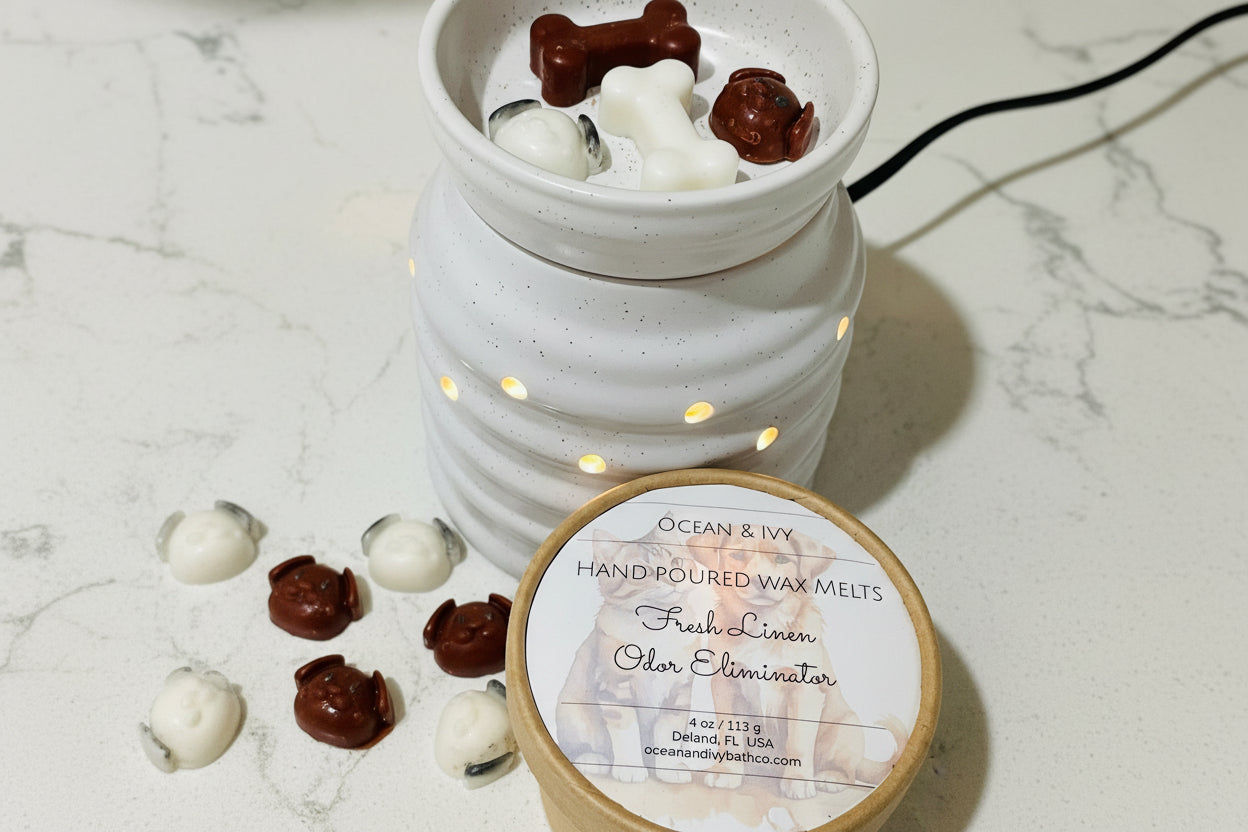 A white container with a lid, filled with hand-poured wax melts. Some wax melts are visible on the lid, and a few are scattered outside the container.