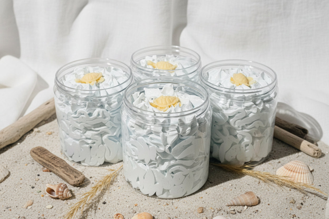 Jars of Sugar Whipped Soap with white foam and a soap turtle on top, displayed on a wooden surface.