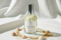 Bottle of Coastal Sunset luxury room spray with decorative elements on a textured surface.