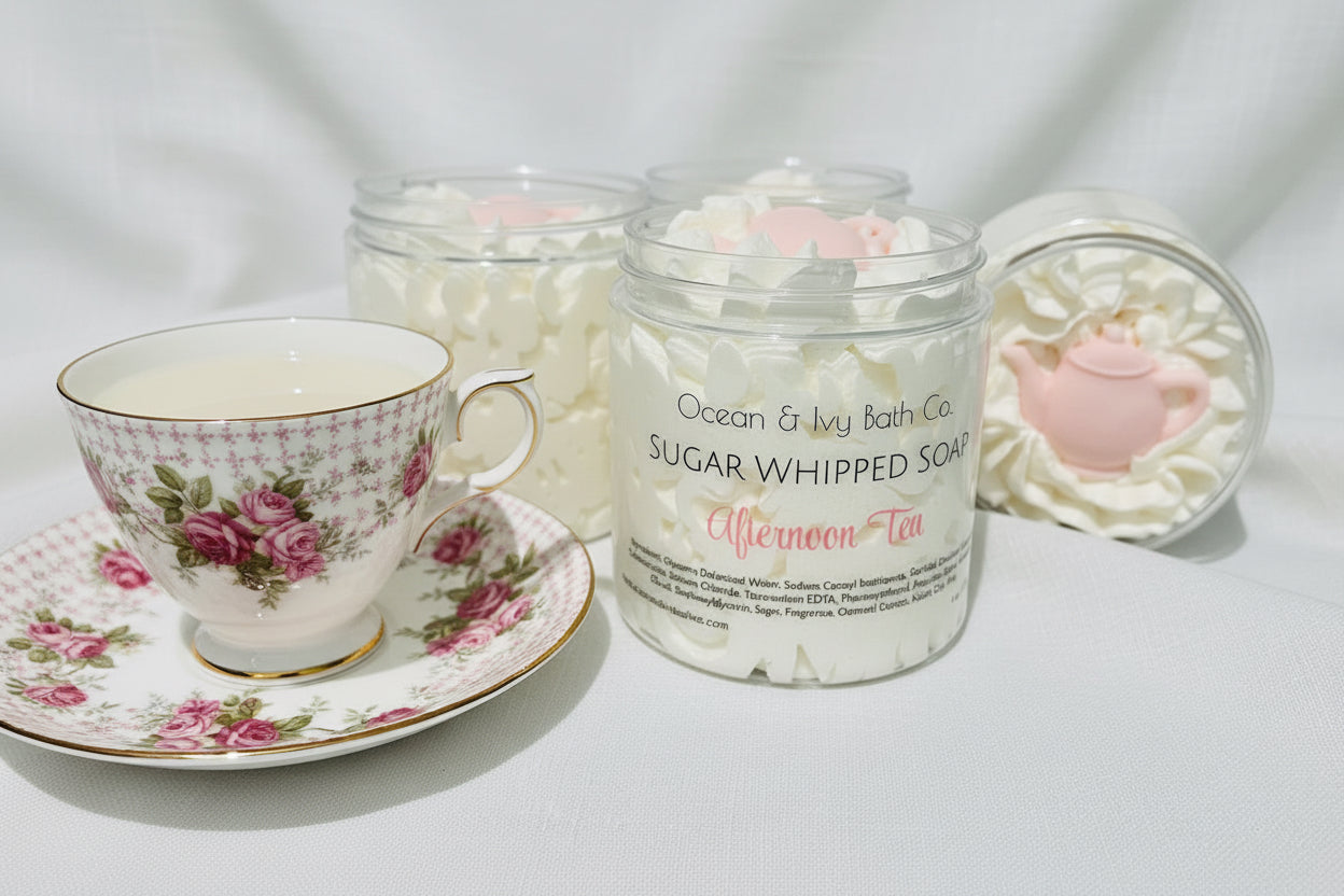 Jar of sugar whipped soap with a pink teapot-shaped container on a white background